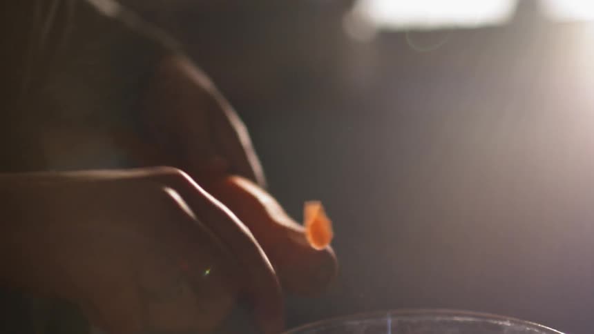 Someone peeling a carrot