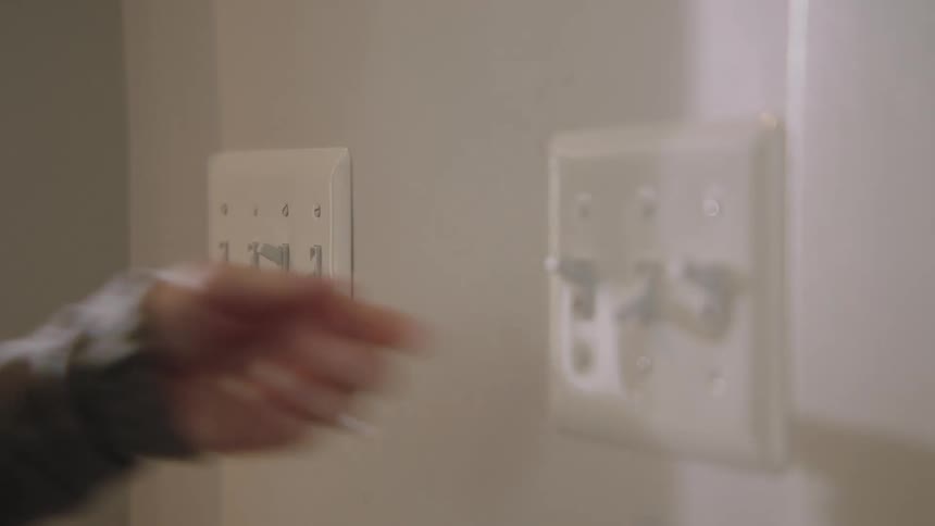 A person turning on lights
