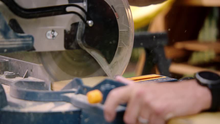 A person is cutting wood with a table saw