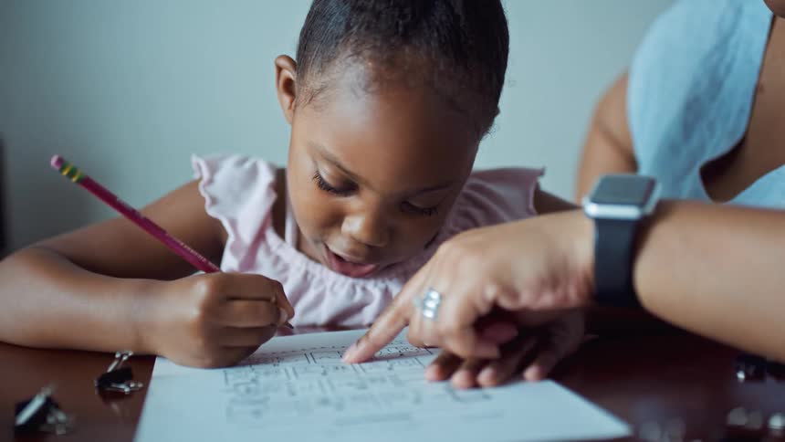Mother helping her daughter on the homework