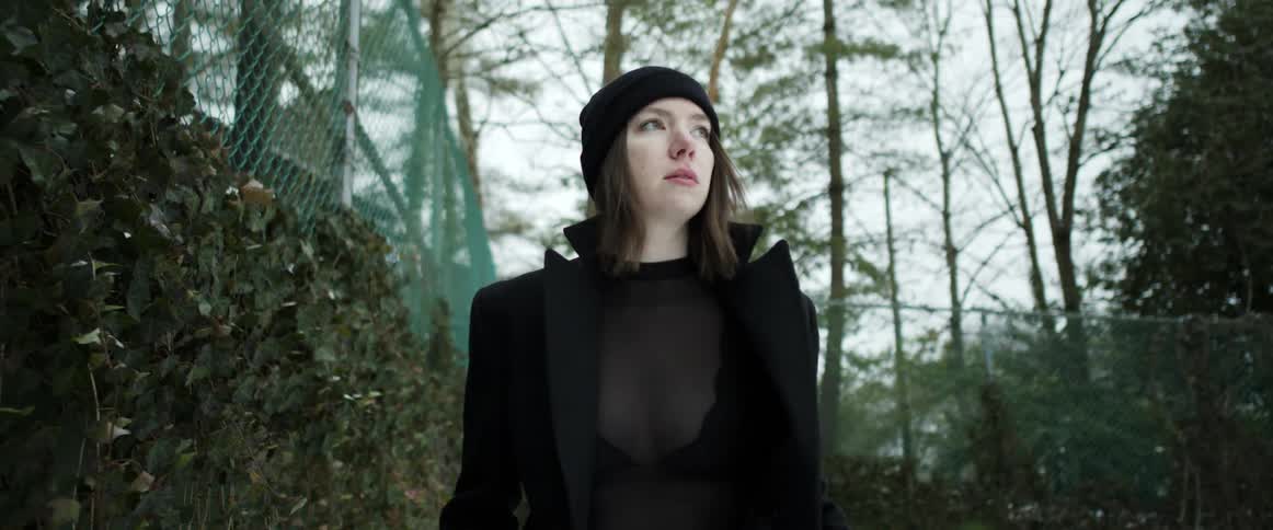 White woman walking alone wearing winter clothing