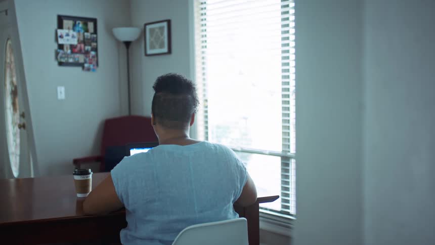 A woman sits at the table with coffee