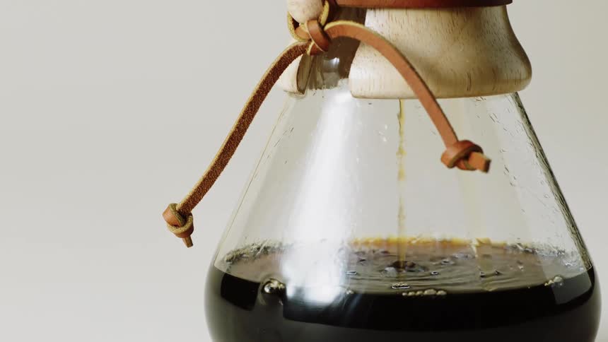 Coffee flowing through a filter into a cup
