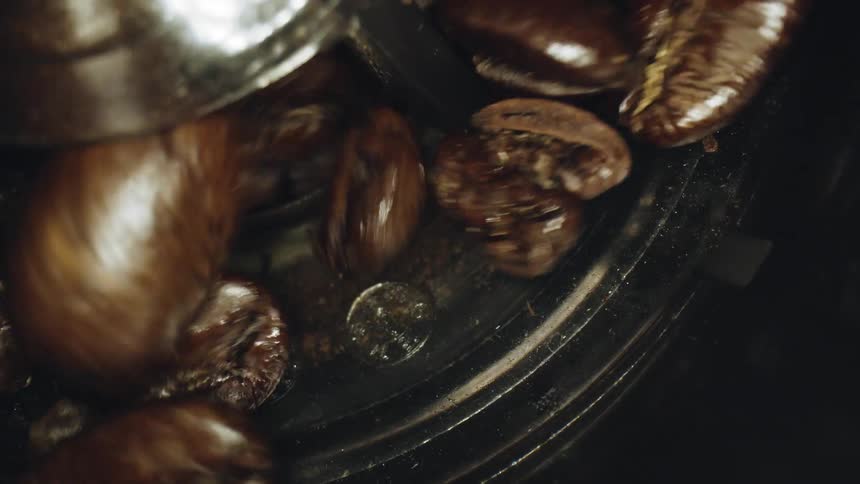 Coffee beans being grind in a machine