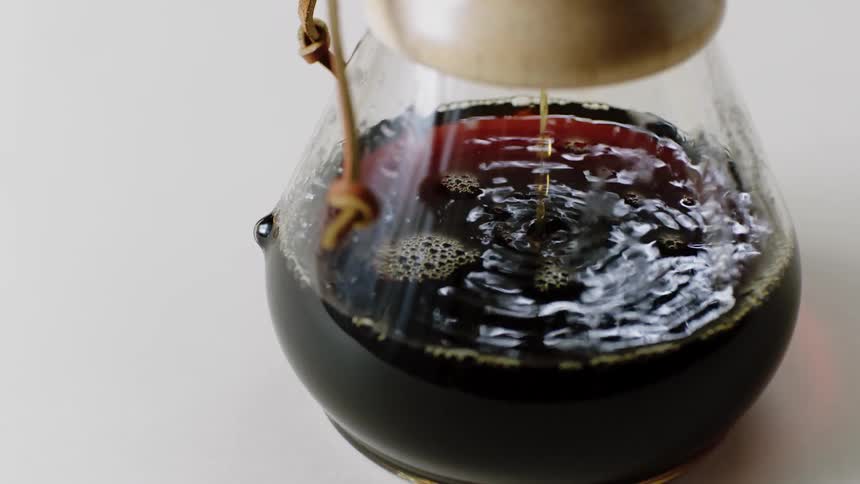 Coffee is brewed in a pour over glass carafe