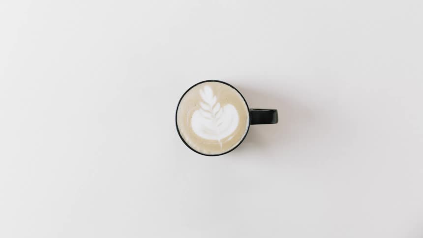 A cup of coffee with a design on top