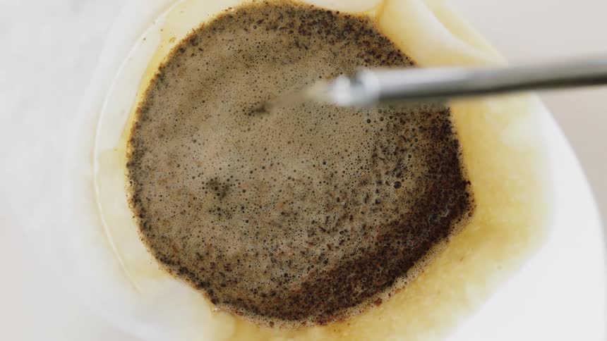 Water being poured over grounds as coffee is being made