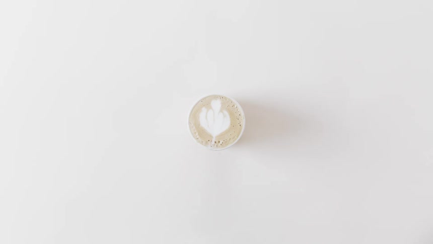 A man sets a cup of coffee down