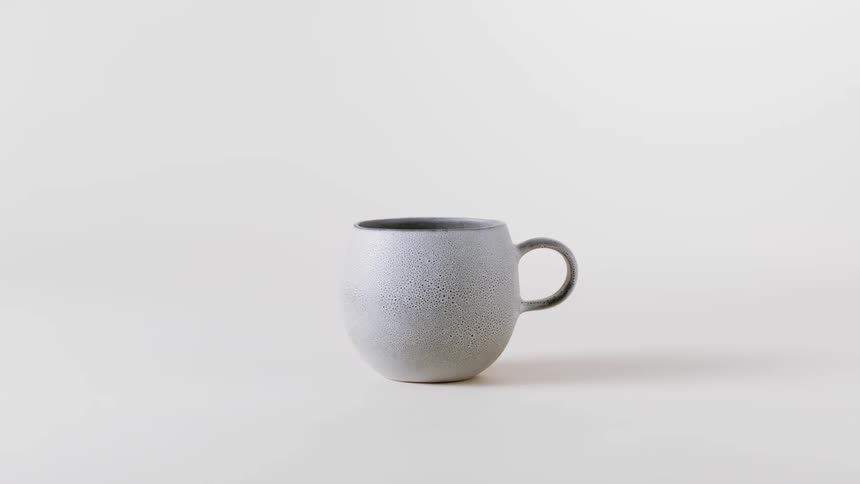 A view of a cup sitting on a white table