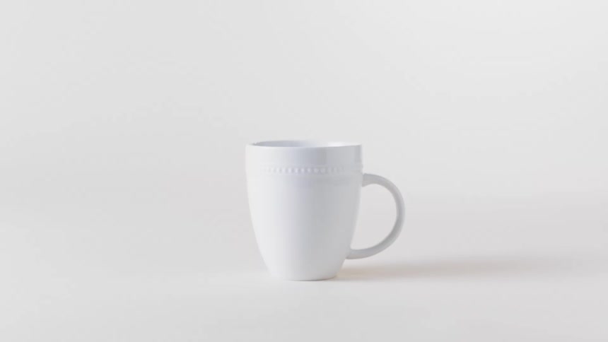 A basic white mug on a white background