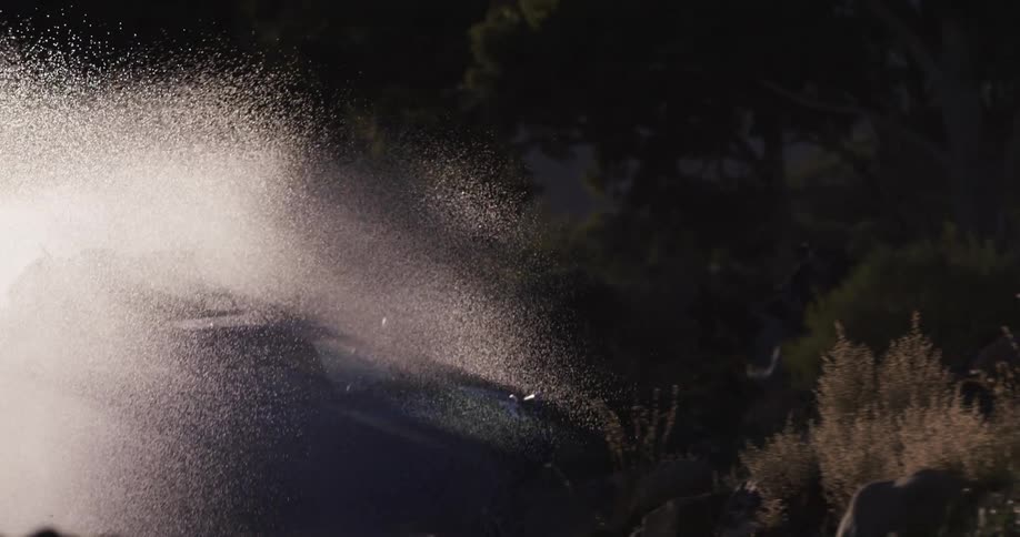 A vehicle drives through the water