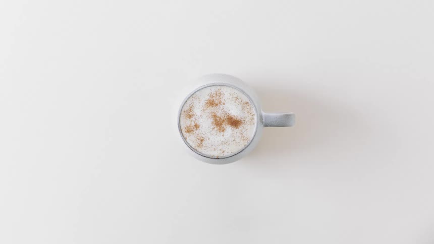 Top view of coffee with foam in blue mug