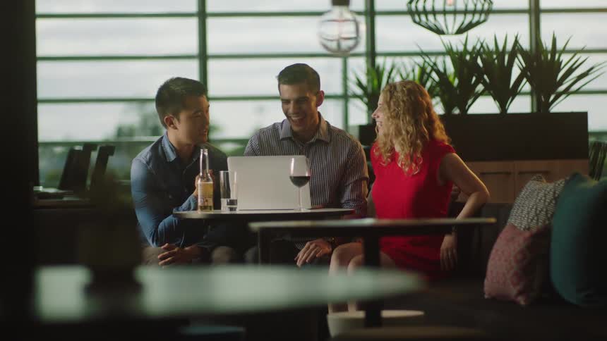 A group of people looking at a laptop