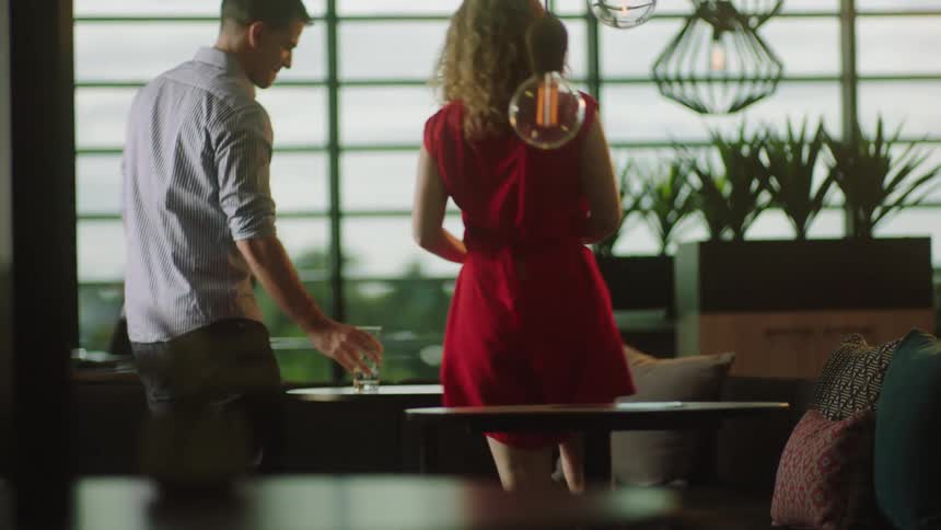 Three people sit at a table with drinks in the restaurant