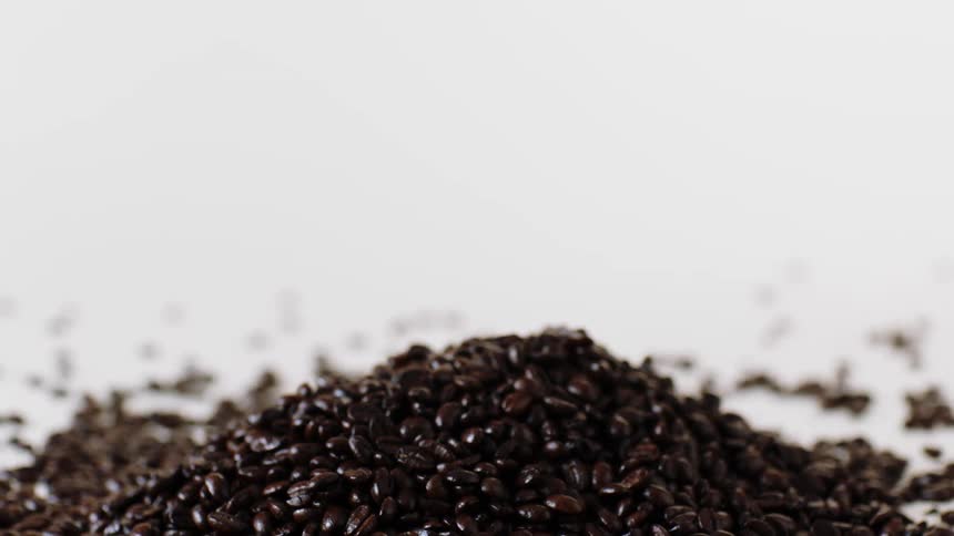 Coffee beans reflecting light with a white background