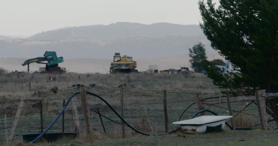 Tractors sitting on a field on a farm