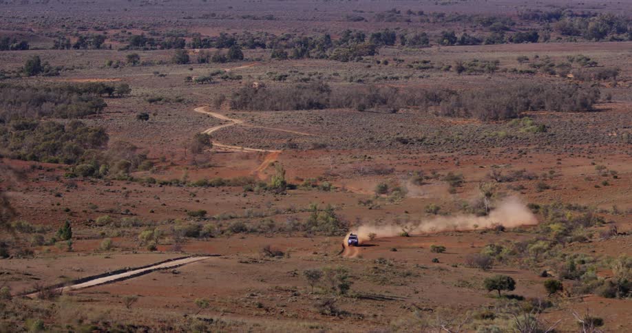 All terrain vehicle driving on the dusty roadson a countryside rural area