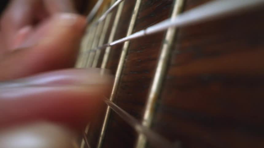 Person strums guitar