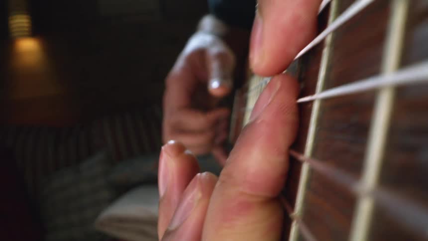 A close up view of someone playing guitar