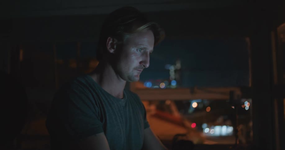 A man working on a laptop at night