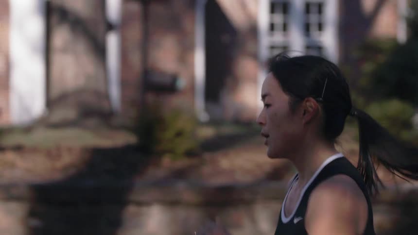 A woman jogging through a residential area