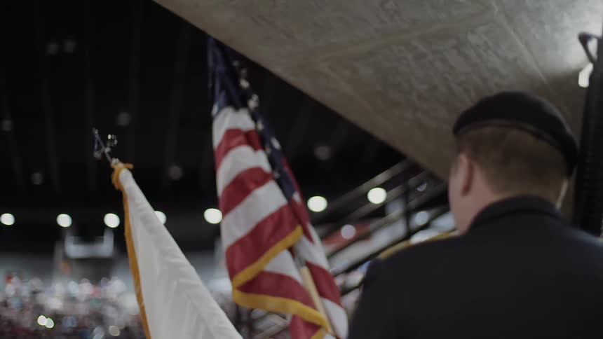 Flags being held by a military color guard