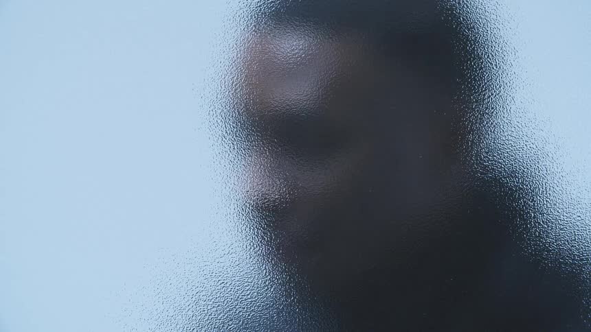 A man behind an opaque glass