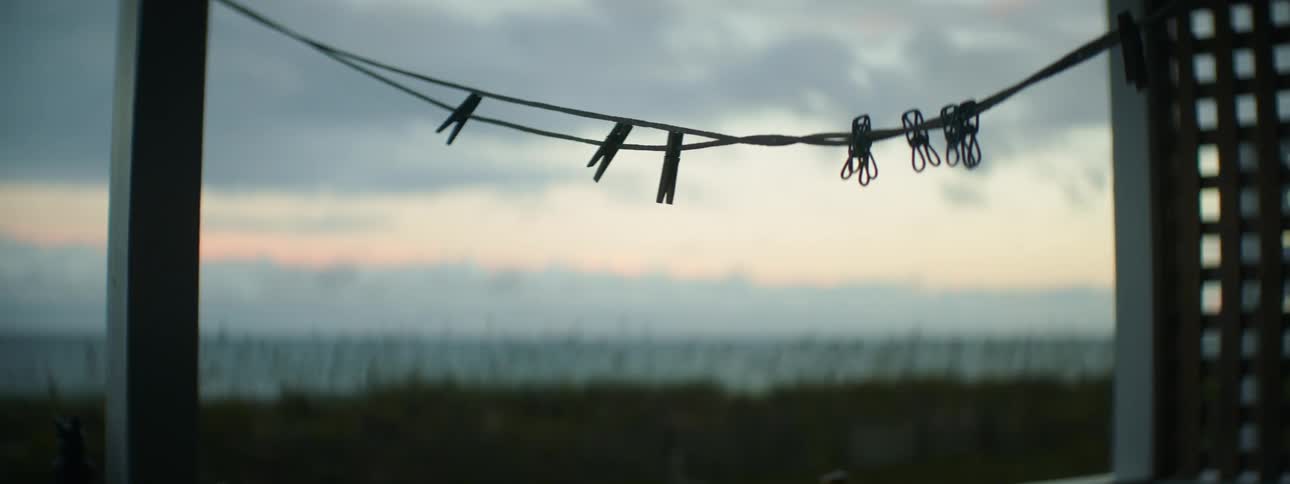 The clothesline blows in the wind at sunset