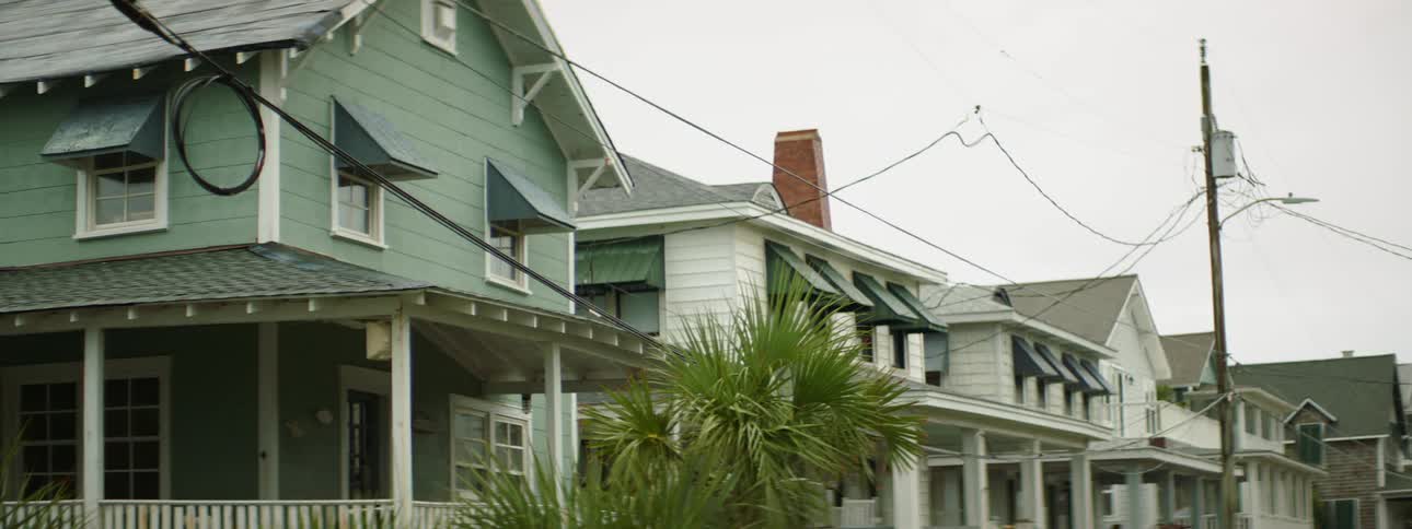 The homes line the street on a cloudy day