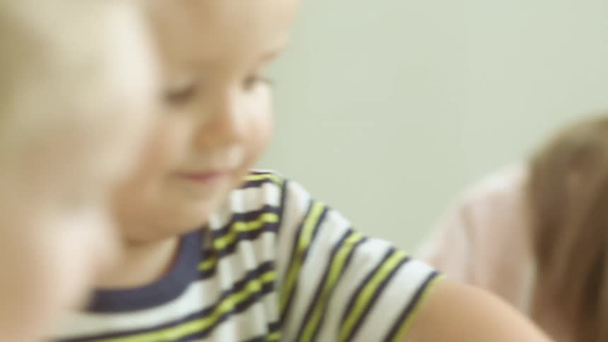 Mother talks to children as they play together