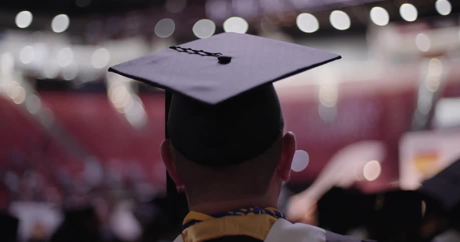 A graduate facing the stage