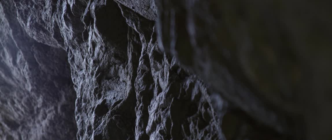 Light is shining inside on a rock wall