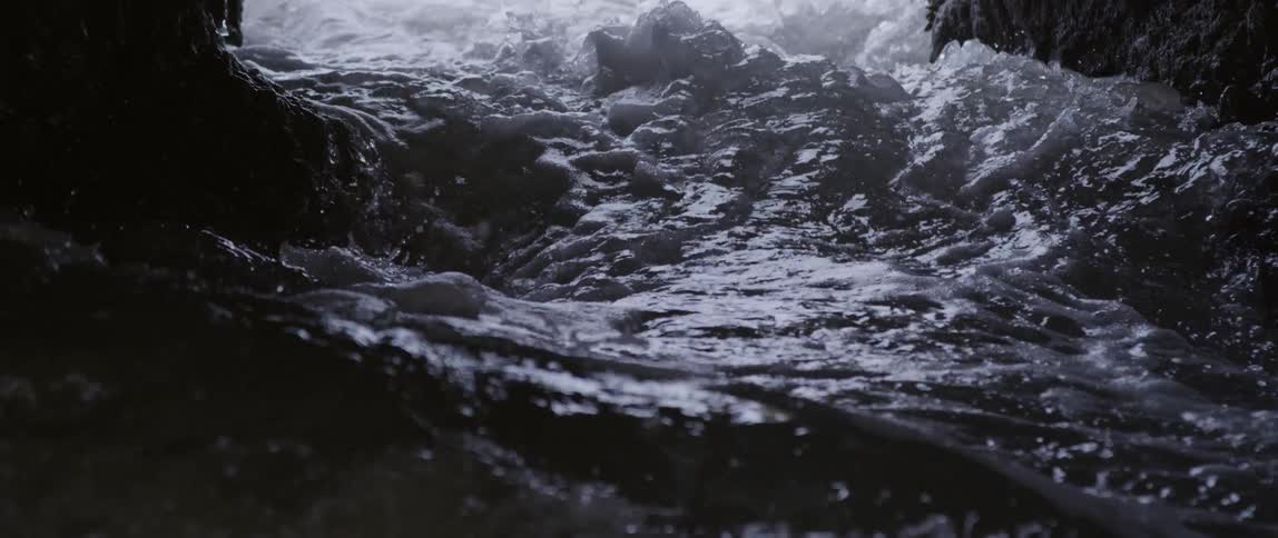 Water is rushing fast over some rocks