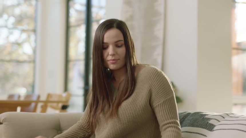 A woman on a couch working from home