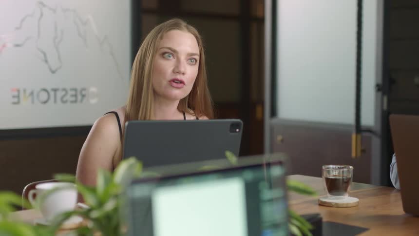 A happy woman speaking in a conference meeting