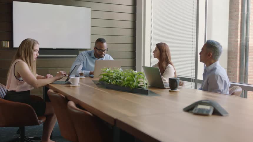 People are having a meeting in a conference room