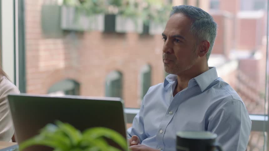 A man listening during a business meeting