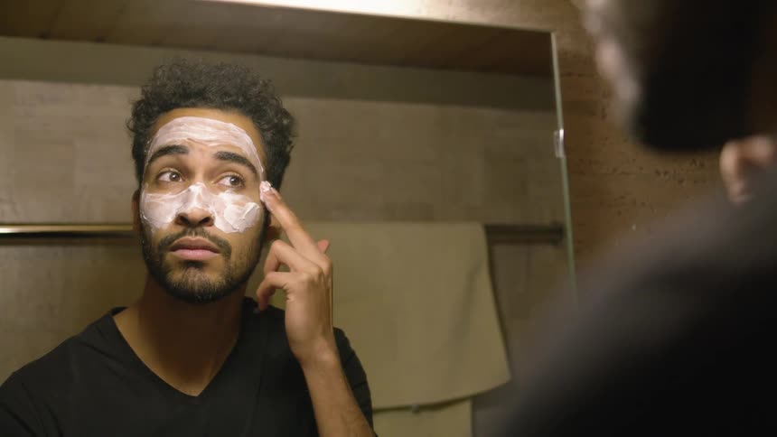 A man putting soap on his face