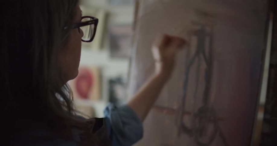 A woman painting on a canvas