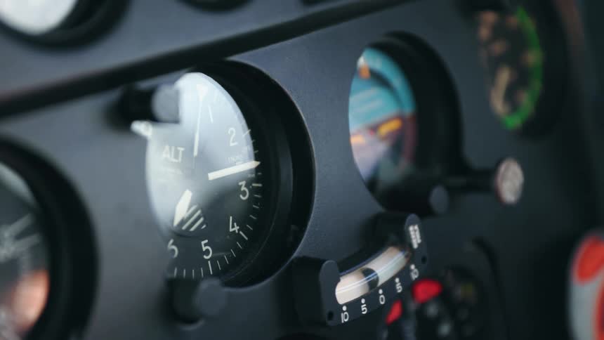 The dials and gauges of a dashboard vibrate and reflect sunlight