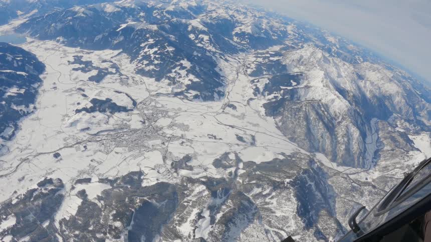 Aerial view from a helicopter of a snowy mountain range at daytime