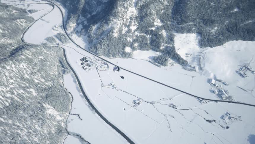 A person is parachuting in the sky during winter