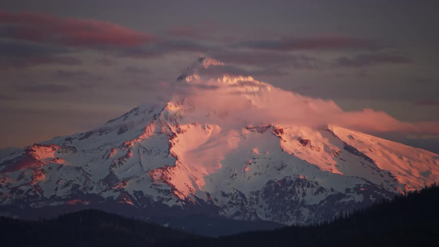 Mount Hood illuminated by a stunning sunset in this awesome winter aerial near Portland Oregon in the Pacific Northwest