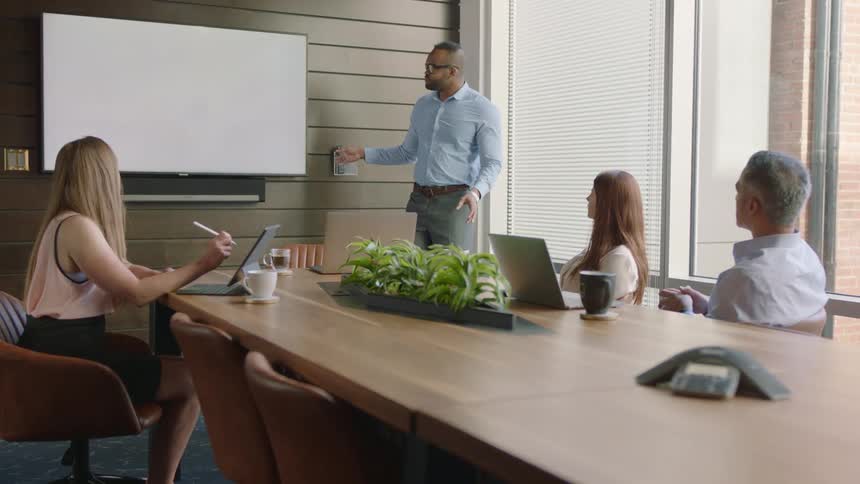 Employees listening to a presentation in conference room