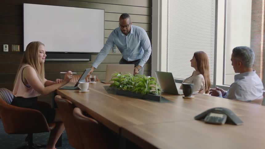 A group of people brainstorm in a meeting in an office