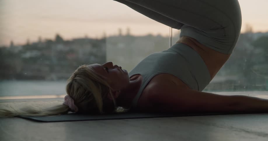 Woman doing yoga outdoors on a mat