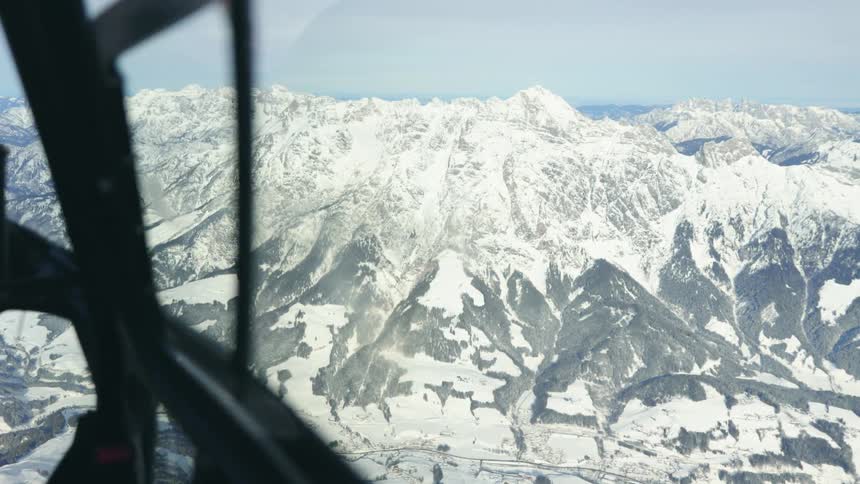 Aerial view of the snow covered peaks of a mountain range from an airplane