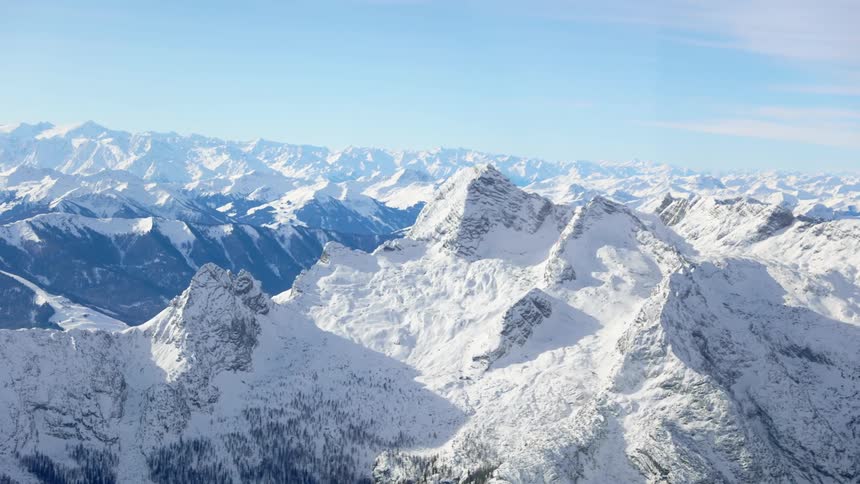 Snow covered mountains with peaks high in the sky