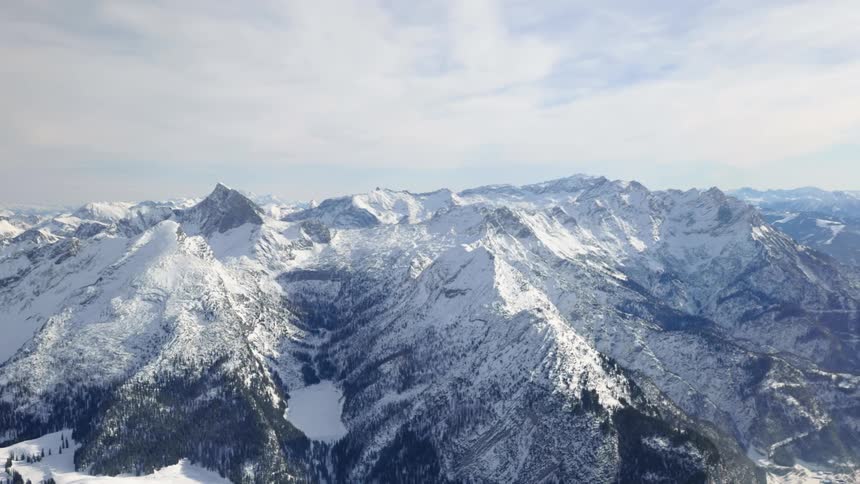 Aerial of snow capped mountain peaks in the arctic