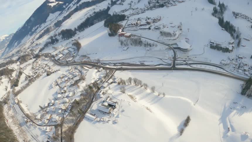 The view of a snowy landscape as seen from a parachute in the sky
